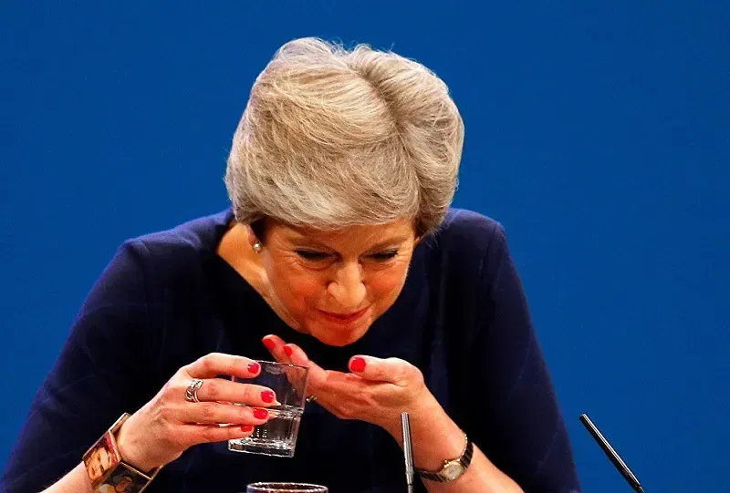 Theresa May chokes on her own words as she wears a Frida Kahlo bracelet for her speech at the Tory conference