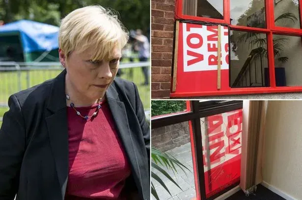 Angela Eagle and her broken office window.