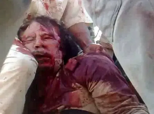 A beaten, battered and bloodied Gaddafi in his final moments.