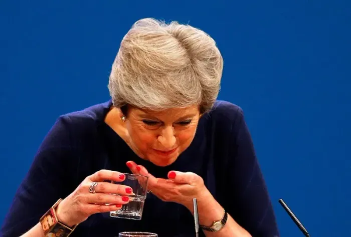 Theresa May chokes on her own words as she wears a Frida Kahlo bracelet for her speech at the Tory conference