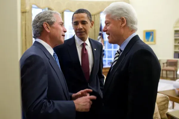 George W. Bush Jr, Barack Obama, and Bill Clinton all smiles, enjoying a friendly chat.